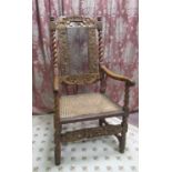 Carolean style walnut elbow chair, with cane work seat, back and cherub cresting, the barley twist