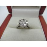 18ct white gold and diamond ring with seven diamonds in a claw set circular mount stamped 18KT, size