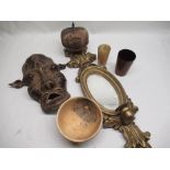 C20th cast brass tribal mask, mahogany games cup, horn beaker and other decorative wood ware
