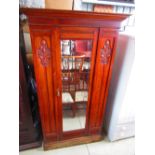 Victorian walnut wardrobe with single mirror door and floral carved panels on a plinth base W113cm