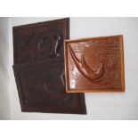 Pair of carved wooden panels depicting medieval style fish and a modern panel of an otter, largest