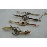 Collection of 9ct gold bar brooches, with coloured stones in decorative central mounts, all