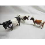 Three Beswick cattle figurines, including John Beswick black and white cow, Ch. Whitehill Mandate