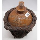 Buchan & Co stoneware whisky flagon in reed wicker basket, impressed Arthur Bell & Sons Ltd, Perth