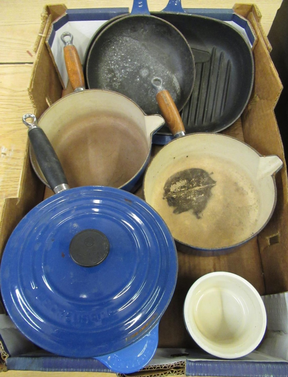 Le Creuset blue enamelled cast iron sauce pan, two other sauce pans lacking lids, two ramekin