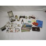 Collection of miscellaneous items including cufflinks, tie clips, train postcards, coronation