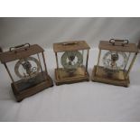 Three Kundo electronic lacquered brass cased mantel clocks