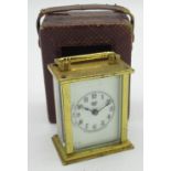 Waterbury Clock Co. miniature brass cased carriage clock timepiece with associated red leather