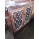 Early C20th oak display cabinet, with two lead glazed doors with two shelves above two panelled