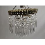 Gilt metal coronet type light fitting, with two graduated tears hung with prismatic drops, ceiling