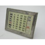 Geo.V ivorine desk calender with hallmarked Sterling silver frame with decorative raised edge by