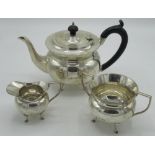 Geo.V three piece tea hallmarked Sterling silver tea service, globular bodies on hoof feet, by