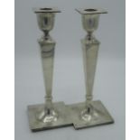 Pair of Geo.V hallmarked Sterling silver Adam style candlesticks tapering columns with Greek key