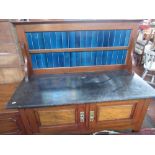 Edwardian walnut washstand, with blue tiled raised back and black marble top above two doors on