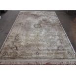 C20th Georgian style silk and wool rug with central roundel, beige ground with scrolling pattern