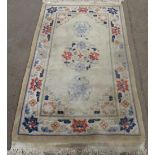 C20th Chinese embossed washed woolen rug, old gold ground with three central medallions and floral