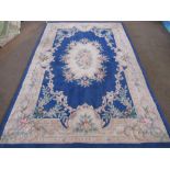 Chinese embossed washed woolen rug, blue ground with central medallion and floral patterned