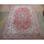 Late C20th Imperial Lano traditional pattern wool rug, brick red ground with central floral