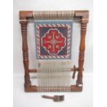 Turned wood weaving loom with comb, and a piece of woven fabric with blue and red double bordered
