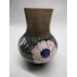 Moorcroft baluster vase decorated in white and blue Anemone pattern on a green ground, impressed
