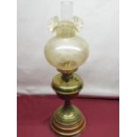 Late C19th brass oil lamp with amber tint shade on floral tapering column and stepped turned