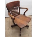 Edwardian oak office swivel armchair, with curved back, square slats and shaped seat on Angus of