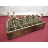 Vintage Coca Cola wooden crate with eight original glass Coca Cola bottles (stamped for delivery