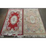 Two late C20th Chinese embossed washed woolen rugs, one beige ground, the other red ground, both