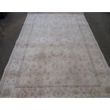 C20th Djhobie wool rug, beige ground with central stylized floral pattern field surrounded by