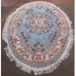 Chinese oval embossed washed woolen rug, central sky blue ground with central rose medallion