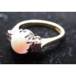 C20th hallmarked 18ct gold ring with oval opal flanked by two round cut diamonds in platinum