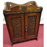 Edwardian oak smokers cabinet, carved rosette twin doors with two drawer fitted interior, with
