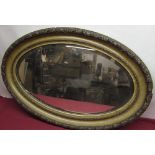 Gilt oval mirror, oval bevelled plate in simulated wood and gesso frame, W84cm D56cm