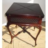 Edwardian mahogany envelope card table, swivel baize lined top with blind fret frieze including