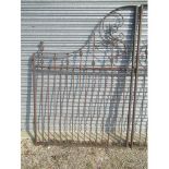 Large pair of arched cast and wrought iron driveway gates, with leaf and pierced decoration
