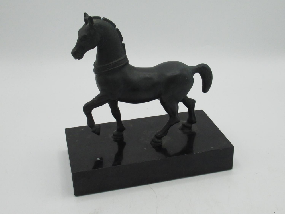 After the Antique, patinated bronze model of a Roman prancing horse, on polished rectangular base,