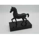 After the Antique, patinated bronze model of a Roman prancing horse, on polished rectangular base,