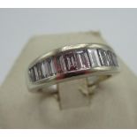 Hallmarked 18ct white gold and diamond ring with fourteen graduated emerald cut, channel set