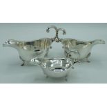 Pair of Geo.VI hallmarked Sterling silver sauce boats with waived edges and C scroll handles on
