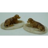 Pair of C20th alabaster models of recumbant hounds, on oval bases, W14.5cm H8cm