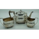 Geo.V hallmarked Sterling silver three piece tea service, stepped shaped rectangular bodies with