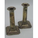 Pair of Geo.V hallmarked Sterling silver dressing table candlesticks with plain column on stepped