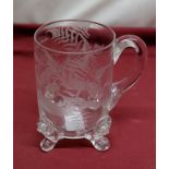 C19th glass tankard with loop handle on scrolled lion prunt feet, engraved with ferns and