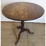 Geo. III oak tripod tea table, circular tilt top on vase turned column support and three