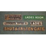 Four cast iron relief painted signs, enamel Ladies Room sign (5)