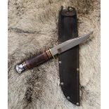 J Nowill bowie knife with clip blade and wooden and leather handle, brass cross guard and steel