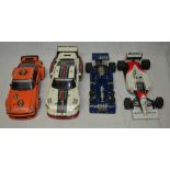 Four Tamiya 1:12 scale static car models, F1 Tyrrell 6 wheeler, F1 Ford Tyrrell and two Porsche