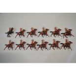 12 vintage Britain’s mounted infantry and officer commanding, with articulated right arms.
