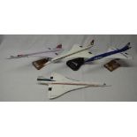 Four 1/100 Concorde models, 3 with stands. These are hand crafted kiln dried wood models from Gtrans