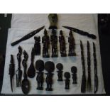 Large collection of African tourist carvings of tribes people, combs, carved wooden knives, spoon